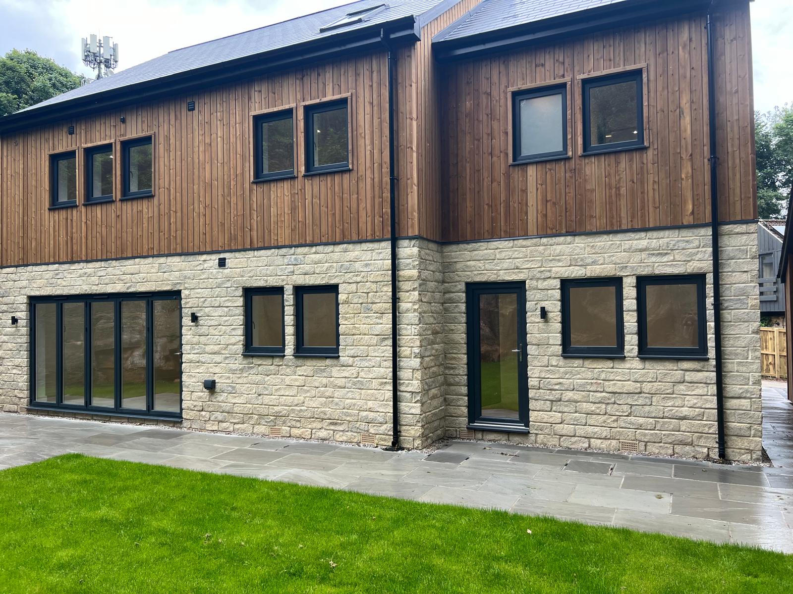 Anthracite PVCu windows on the rear of a modern extension, supplied by WGS Glazing