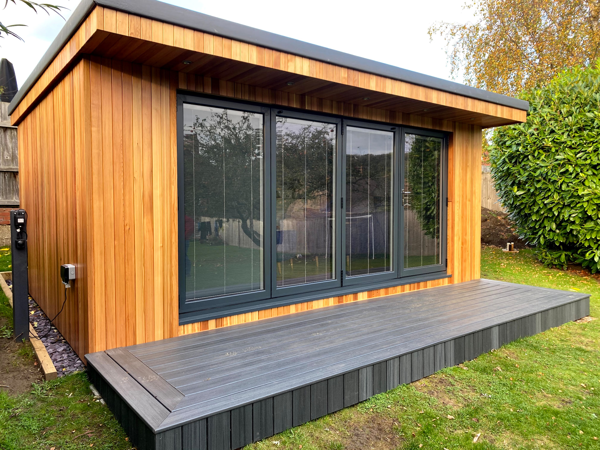 Anthracite aluminium bifold doors on a garden room, installed by WGS Glazing